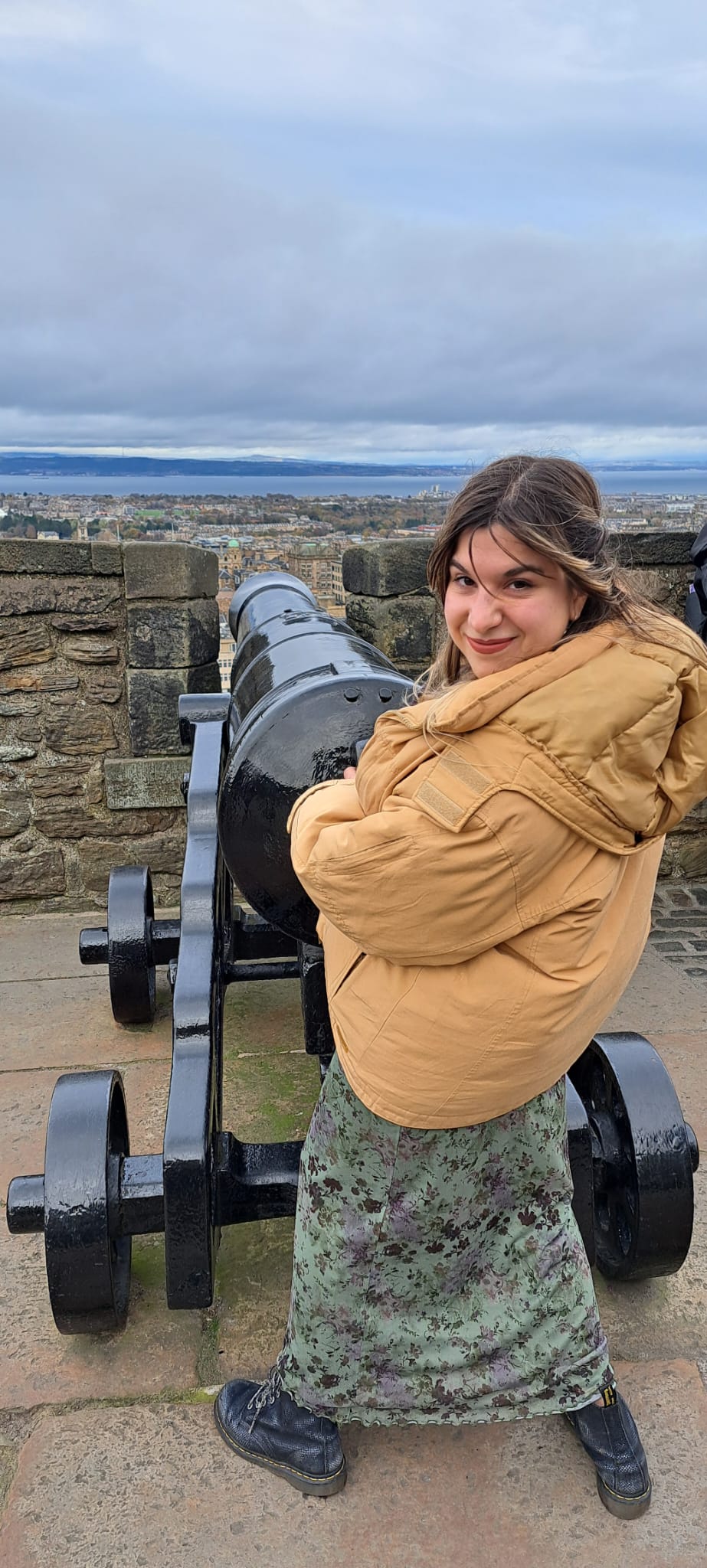 Girl looking at camera playfully handling a cannon